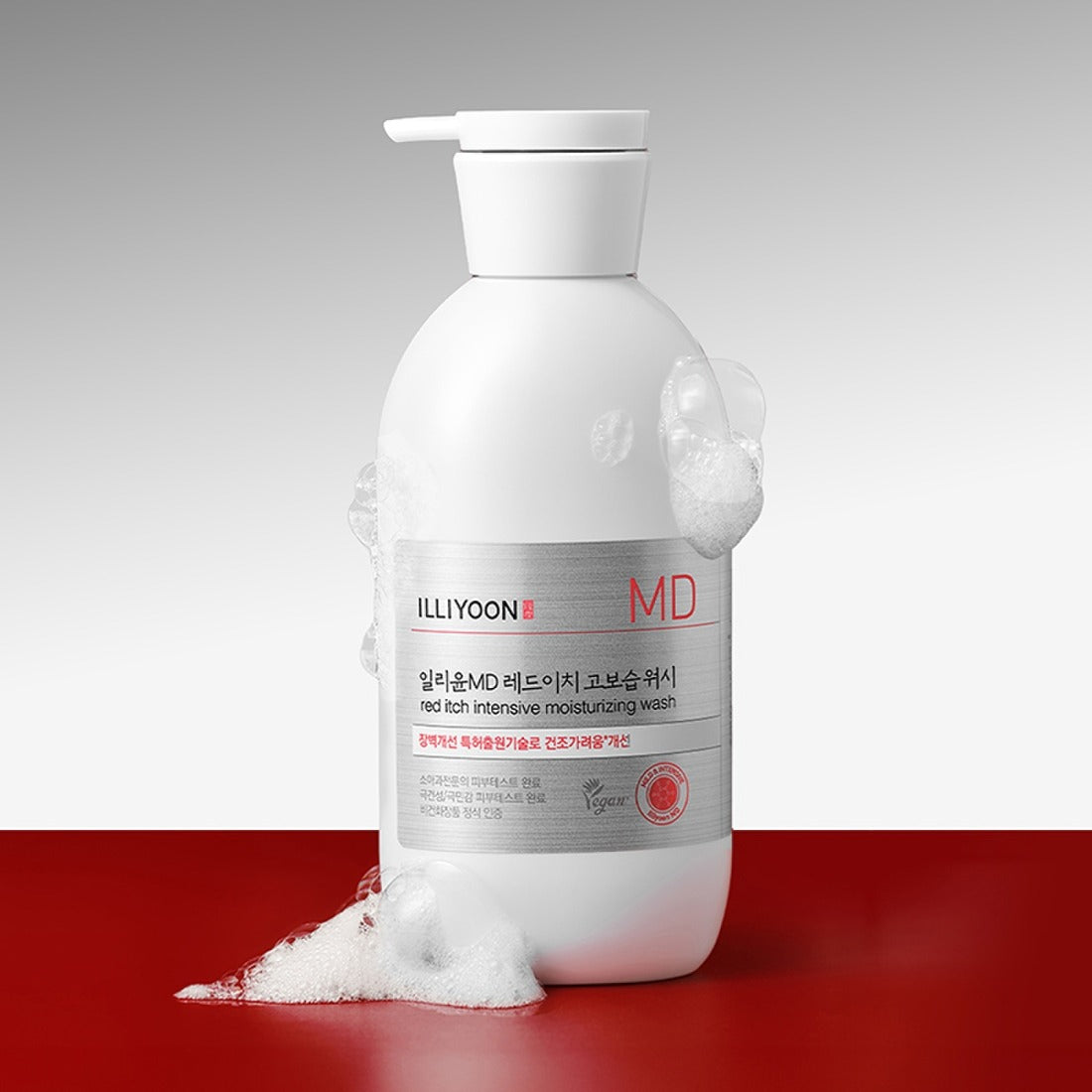 Bottle of ILLIYOON Redich High Moisture Wash 470g on a red surface with foam.