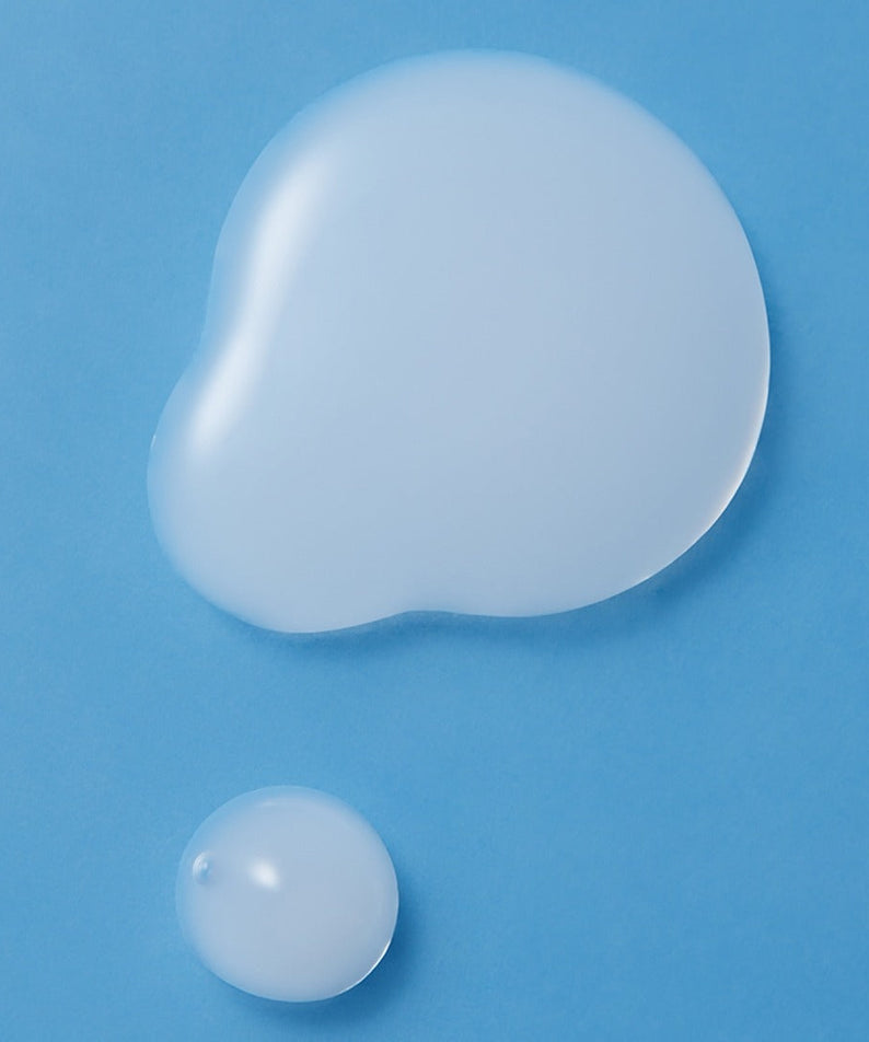 Texture of ILLIYOON Ceramide Ato Moisturizing Skin 250ml on blue background, showcasing its smooth and hydrating properties.