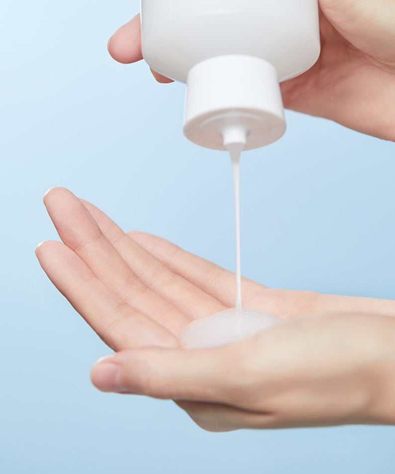 Applying ILLIYOON Ceramide Ato Moisturizing Skin 250ml on hand for hydration and nourishment.