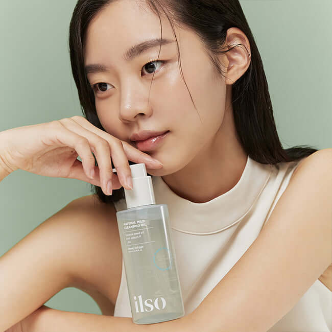 Woman holding ILSO Pore-relief Cleansing Oil 200ml, showcasing skincare product for pore relief and cleansing.