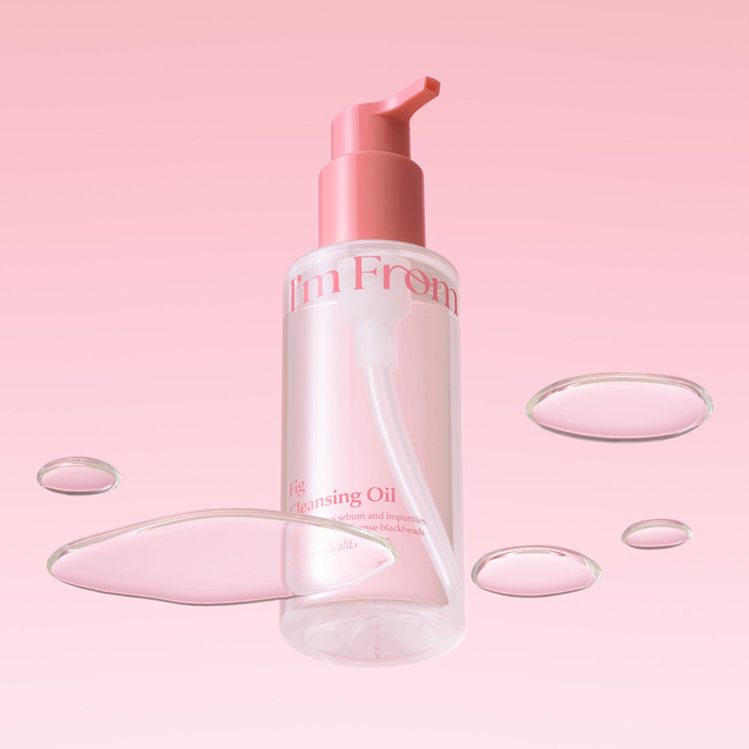 I'M FROM Fig Cleansing Oil 200ml bottle with floating oil drops on pink background.