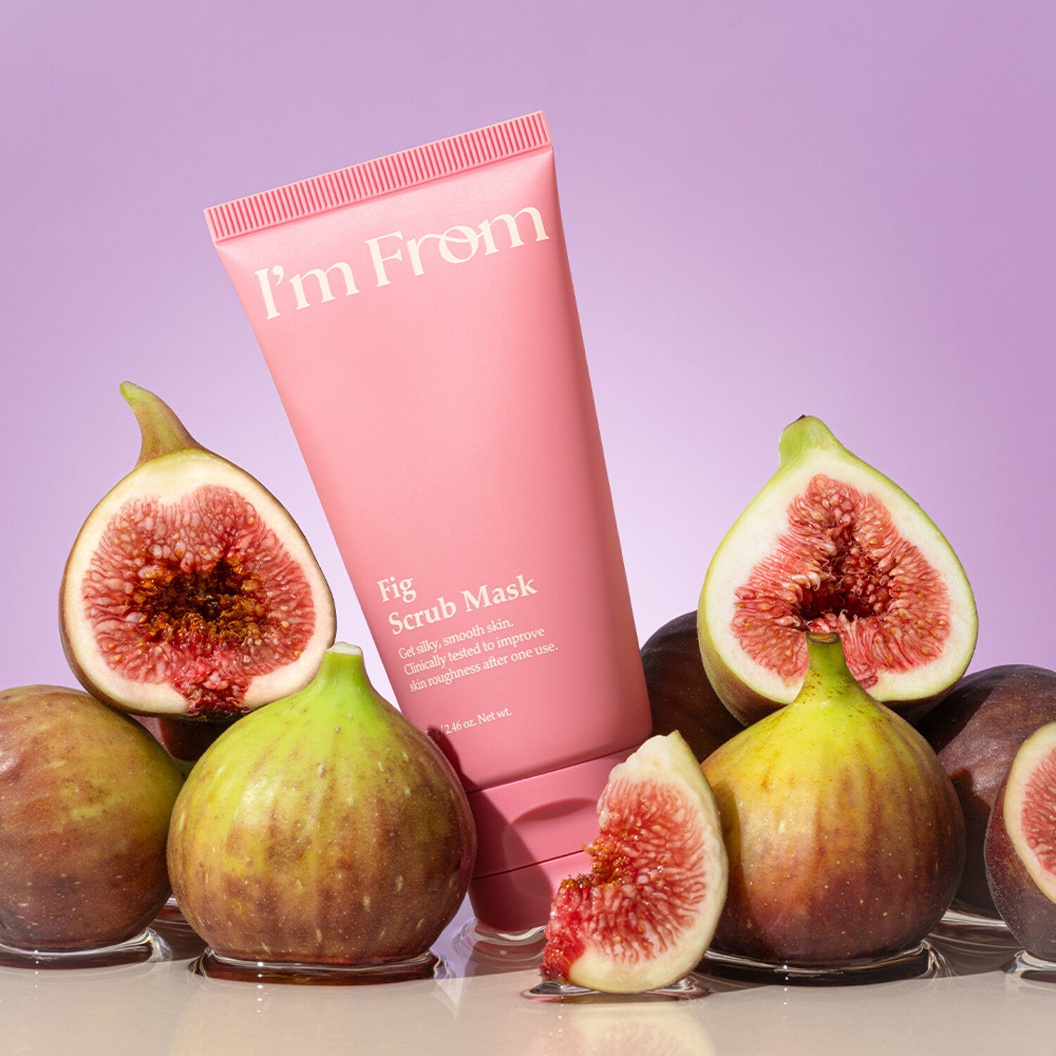 I'M FROM Fig Scrub Mask surrounded by fresh figs against a purple background, showcasing the product's natural ingredients.