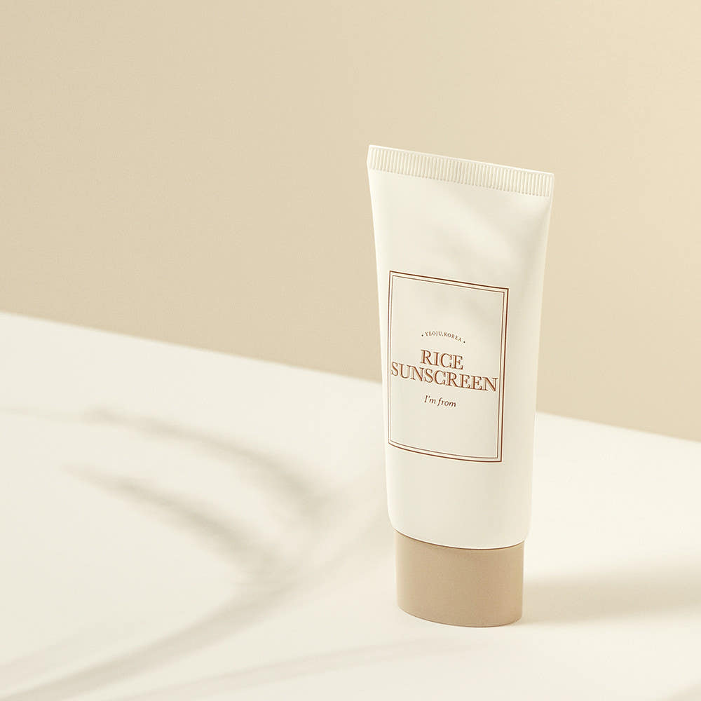 I'M FROM Rice Sunscreen 50ml tube on a beige background with shadow.