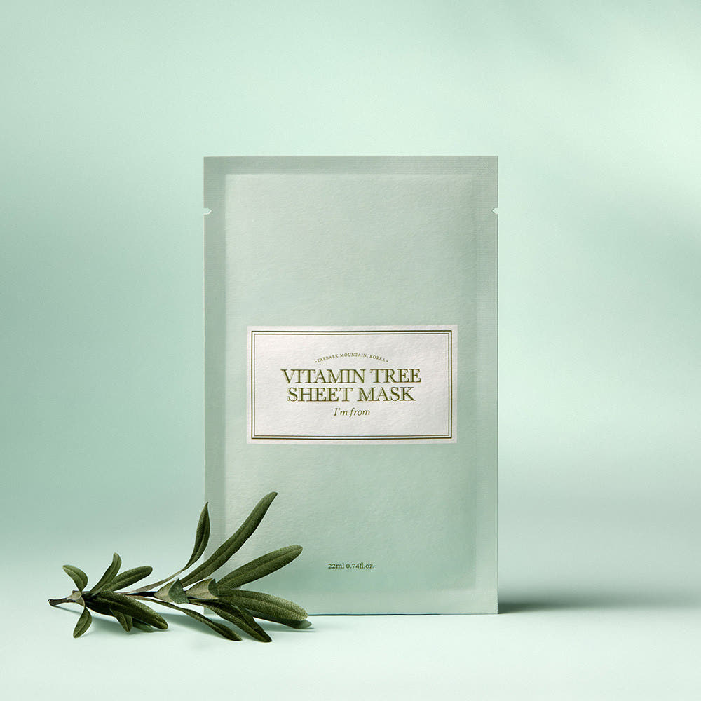 I'M FROM Vitamin Tree Sheet Mask displayed with greenery on a light green background.