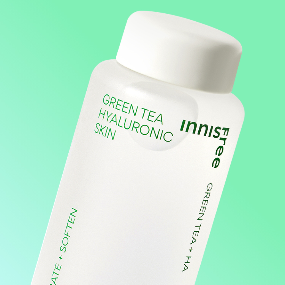 INNISFREE Green tea Hyaluronic Skin 170ml bottle on a green background showcasing product design and label information.