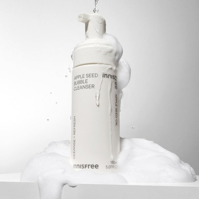 INNISFREE Apple Seed Bubble Cleanser 150ml foaming bottle with lather on a white background.