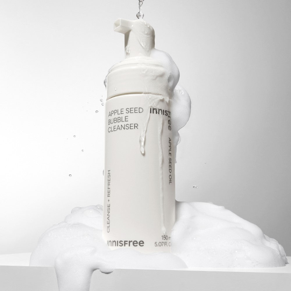 INNISFREE Apple Seed Bubble Cleanser 150ml foaming bottle with lather on a white background.