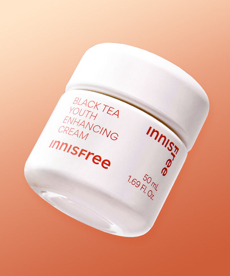 INNISFREE Black Tea Youth Enhancing Cream 50ml in white jar with peach background