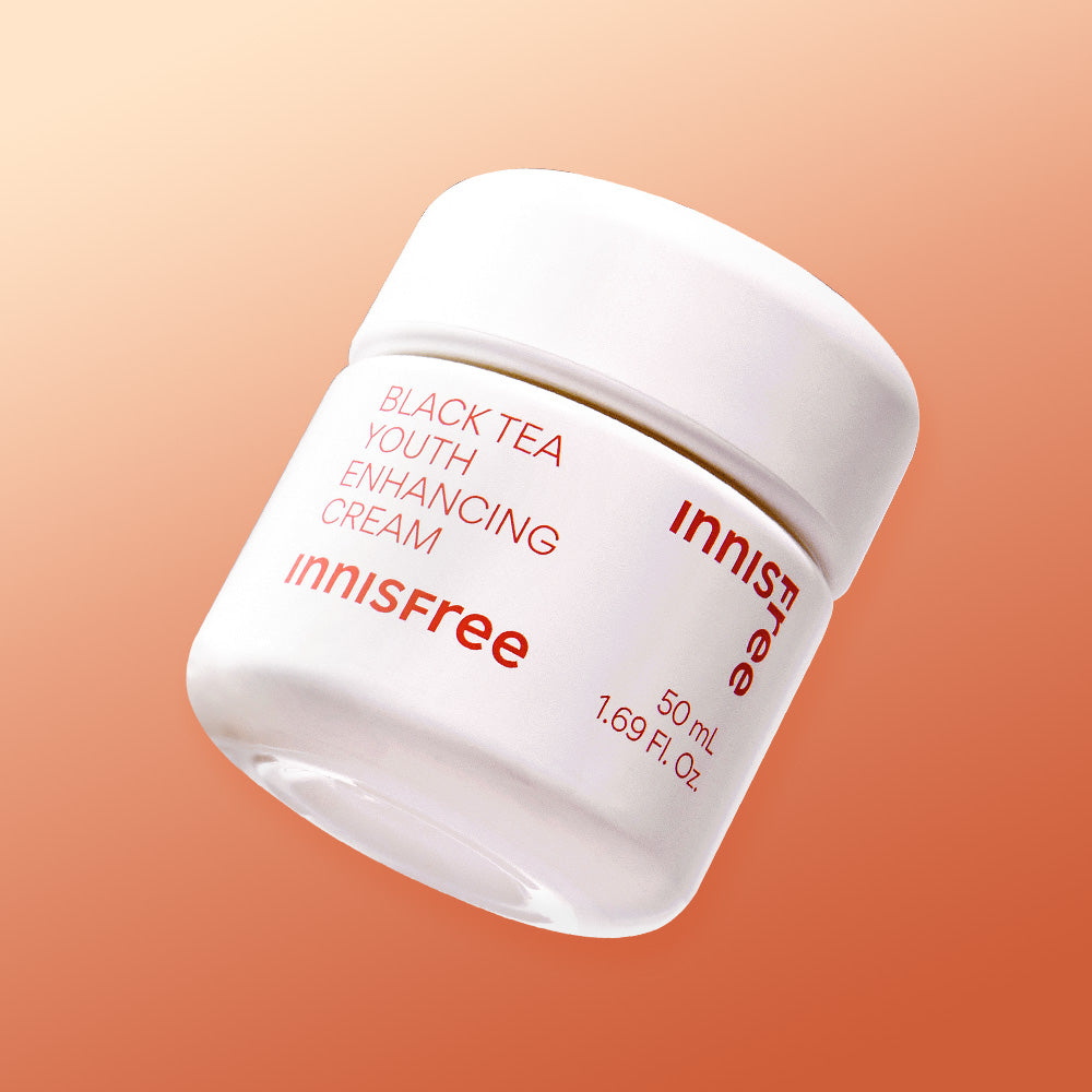 INNISFREE Black Tea Youth Enhancing Cream 50ml in white jar with peach background