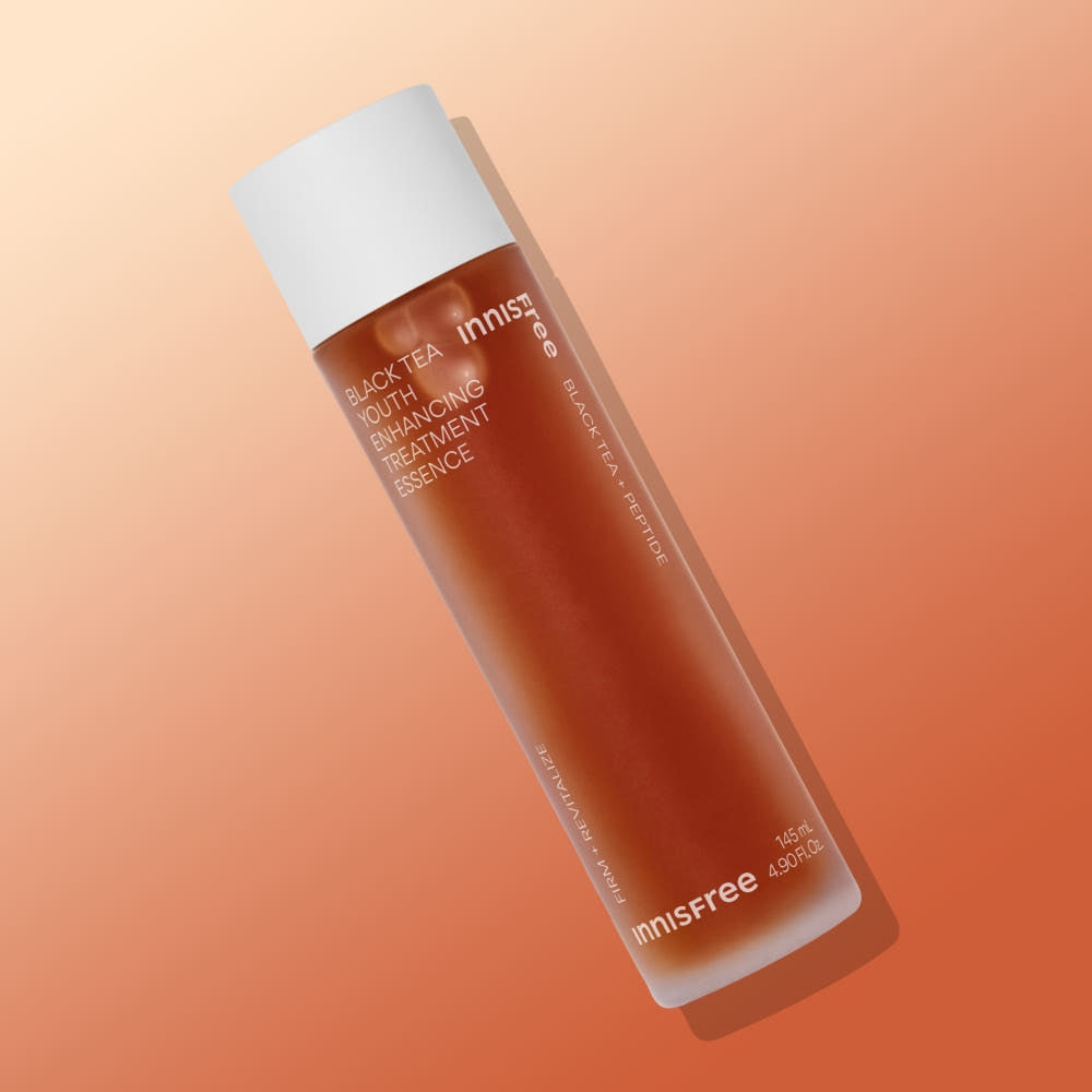 INNISFREE Black Tea Youth Enhancing Treatment Essence shown on gradient background