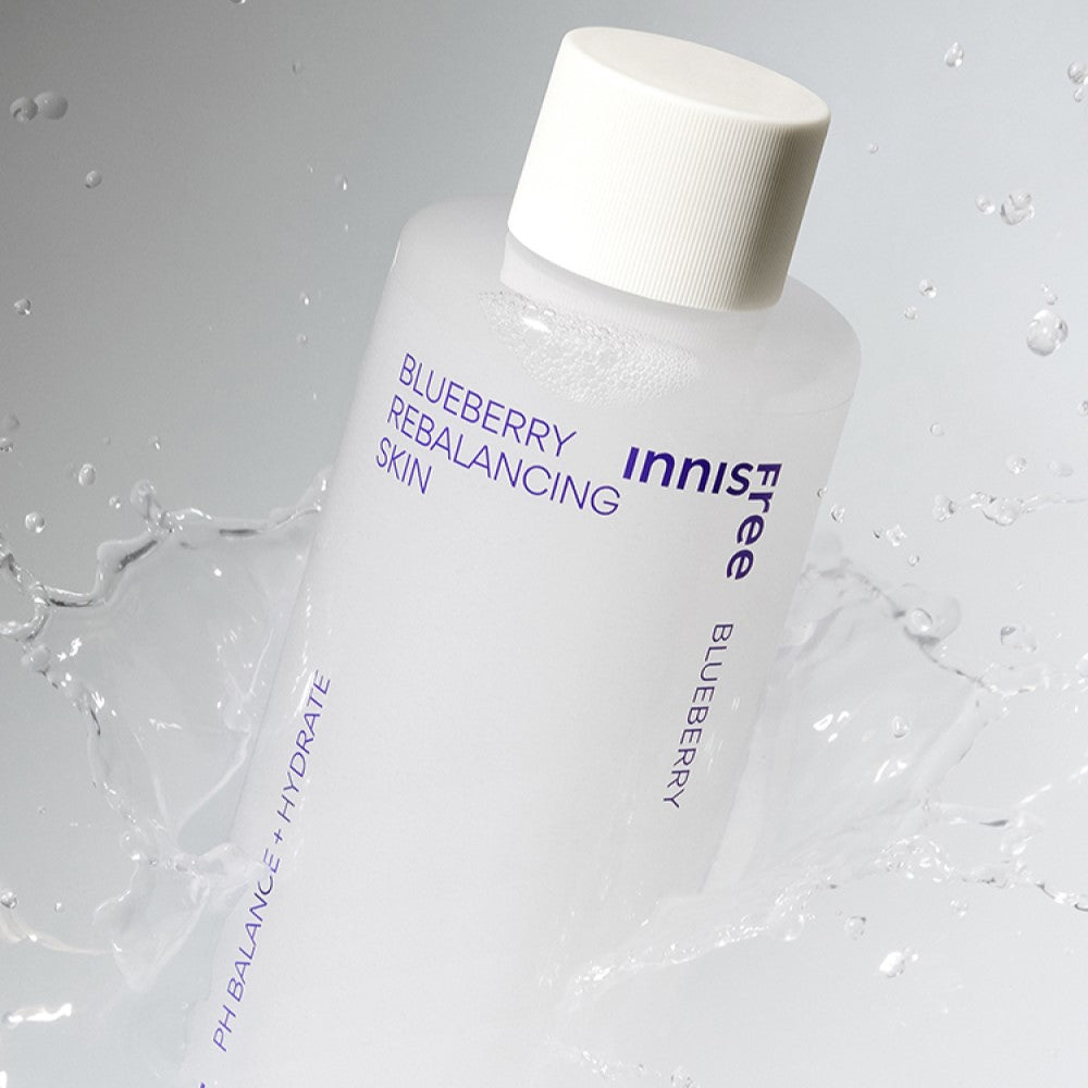 INNISFREE Blueberry Rebalancing Skin toner bottle with splash effect, showcasing refreshing hydration.