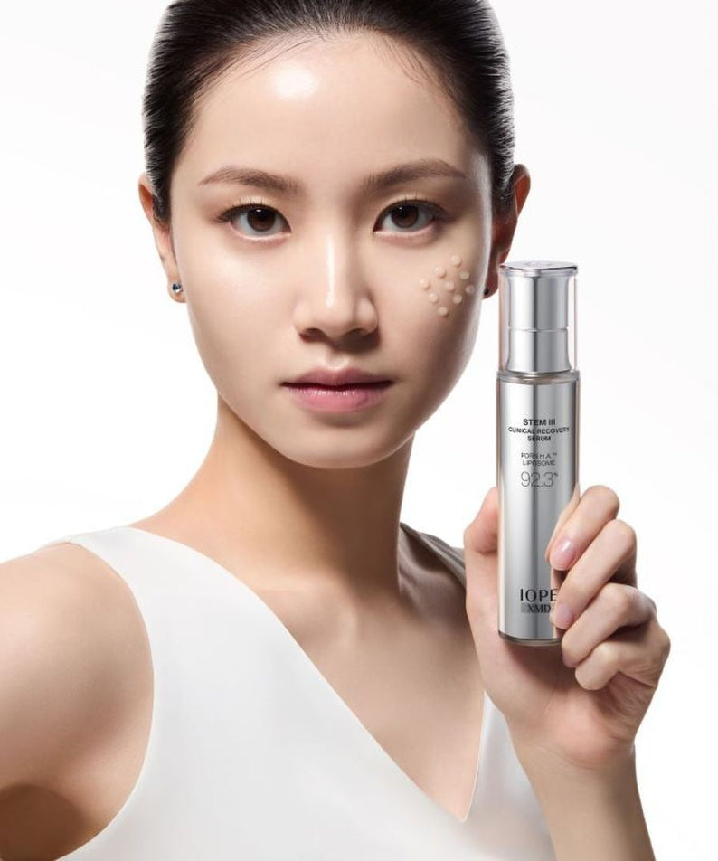 IOPE XMD Stem3 Clinic Recoery Serum 50ml held by model showcasing skincare benefits.