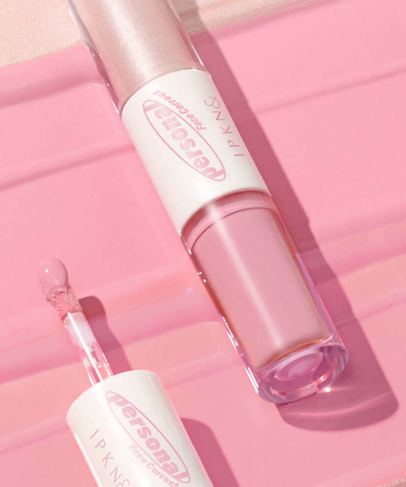 IPKN Personal Tone Cheek Lighter Duo (Cool Lighter) on pink surface highlighting its sleek design and color