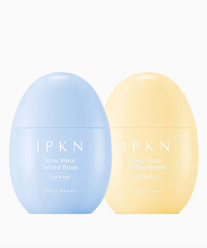 Two bottles of IPKN Tone Wear Tinted Base in icy blue and soft lemon shades with SPF35, PA+++, ideal for even skin tone.