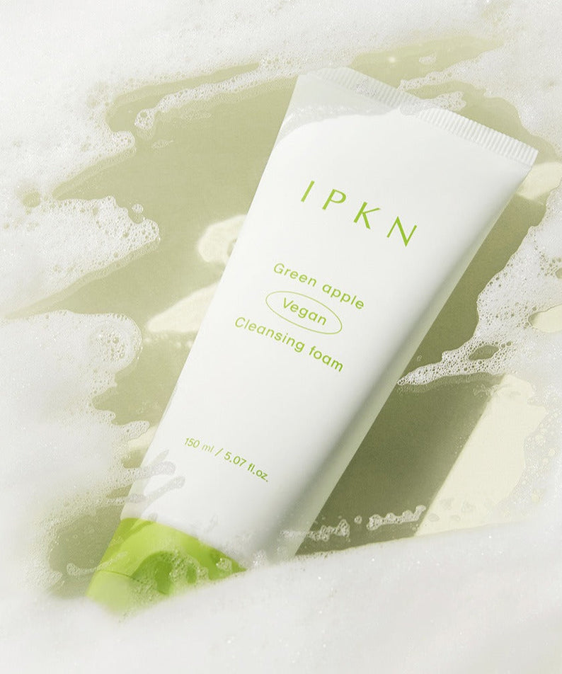 IPKN Green Apple Vegan Cleansing Foam 150ml lying on foam, showcasing the product packaging.