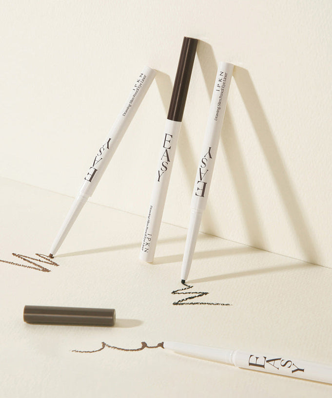 IPKN Easy Drawing Slim Pencil Eyeliner displayed on a light background with swatches, showing its precision and smooth application.