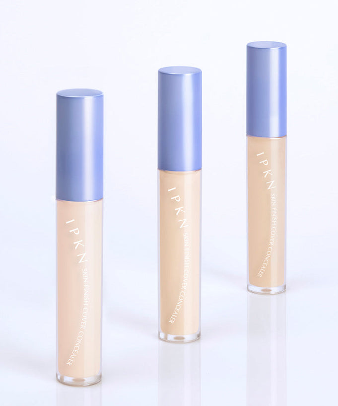 Three bottles of IPKN Skin Finish Cover Concealer SPF30 PA++ with blue caps on a white background.