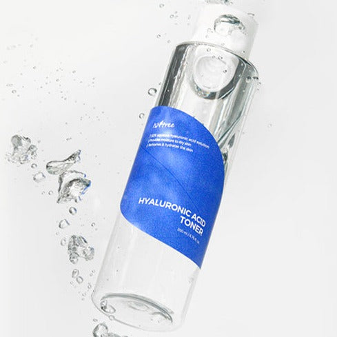 ISNTREE Hyaluronic Acid Toner bottle surrounded by water droplets, emphasizing its hydrating properties.