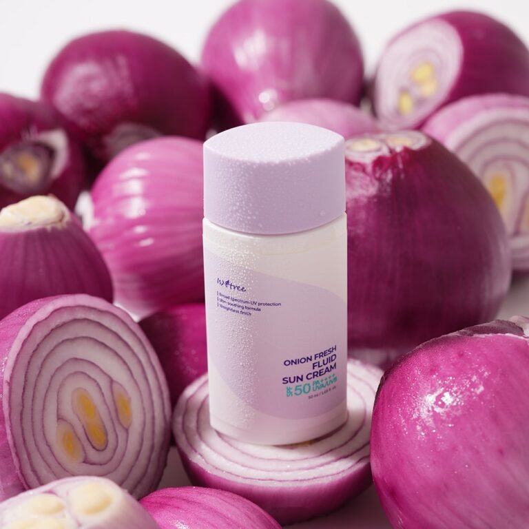 ISNTREE Onion fresh Fluid Sun Cream 50ml bottle surrounded by sliced red onions, highlighting the product's unique ingredients and packaging.