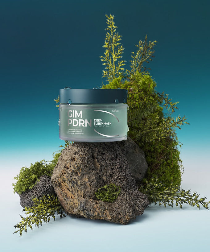 ISNTREE Gim PDRN Deep SLeep Mask 80ml on rocks with greenery background