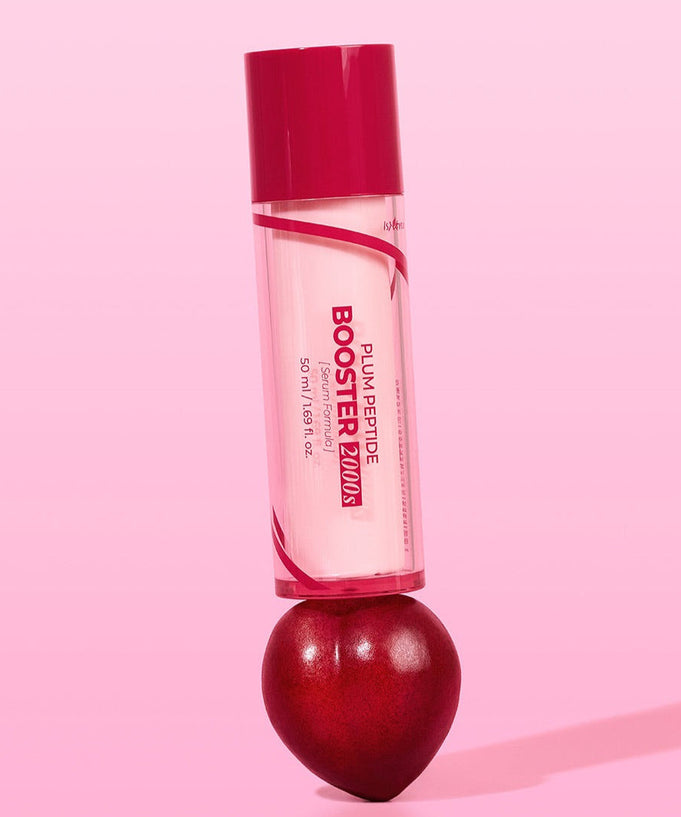 ISNTREE Plum Peptide Booster 2000s 50ml standing on a plum on a pink background