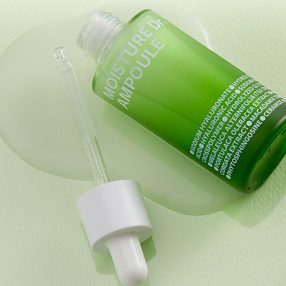 ISOI Moisture Dr Ampoule 40ml with dropper on green surface, showcasing hydration serum packaging