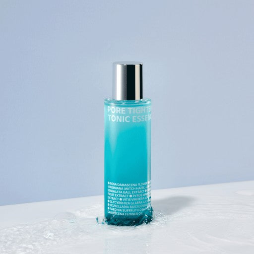 ISOI Pore Tightening Tonic Essence 130ml bottle with blue liquid against a light blue background
