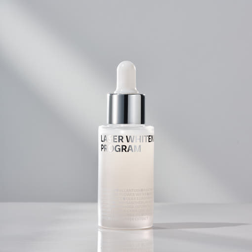 ISOI Whitening Ampoule/Laser Whitening Program 30ml in a sleek bottle on a smooth surface.