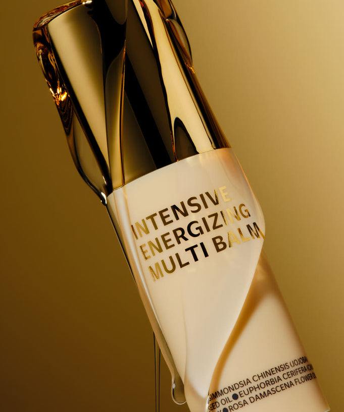 ISOI Intensive Energizing Multi-Balm 10g bottle on a gold background, highlighting the luxurious product design.