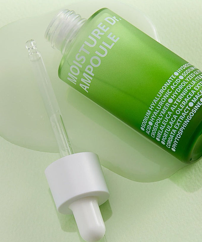 ISOI Moisture Dr Ampoule 40ml with dropper on green surface, showcasing hydration serum packaging
