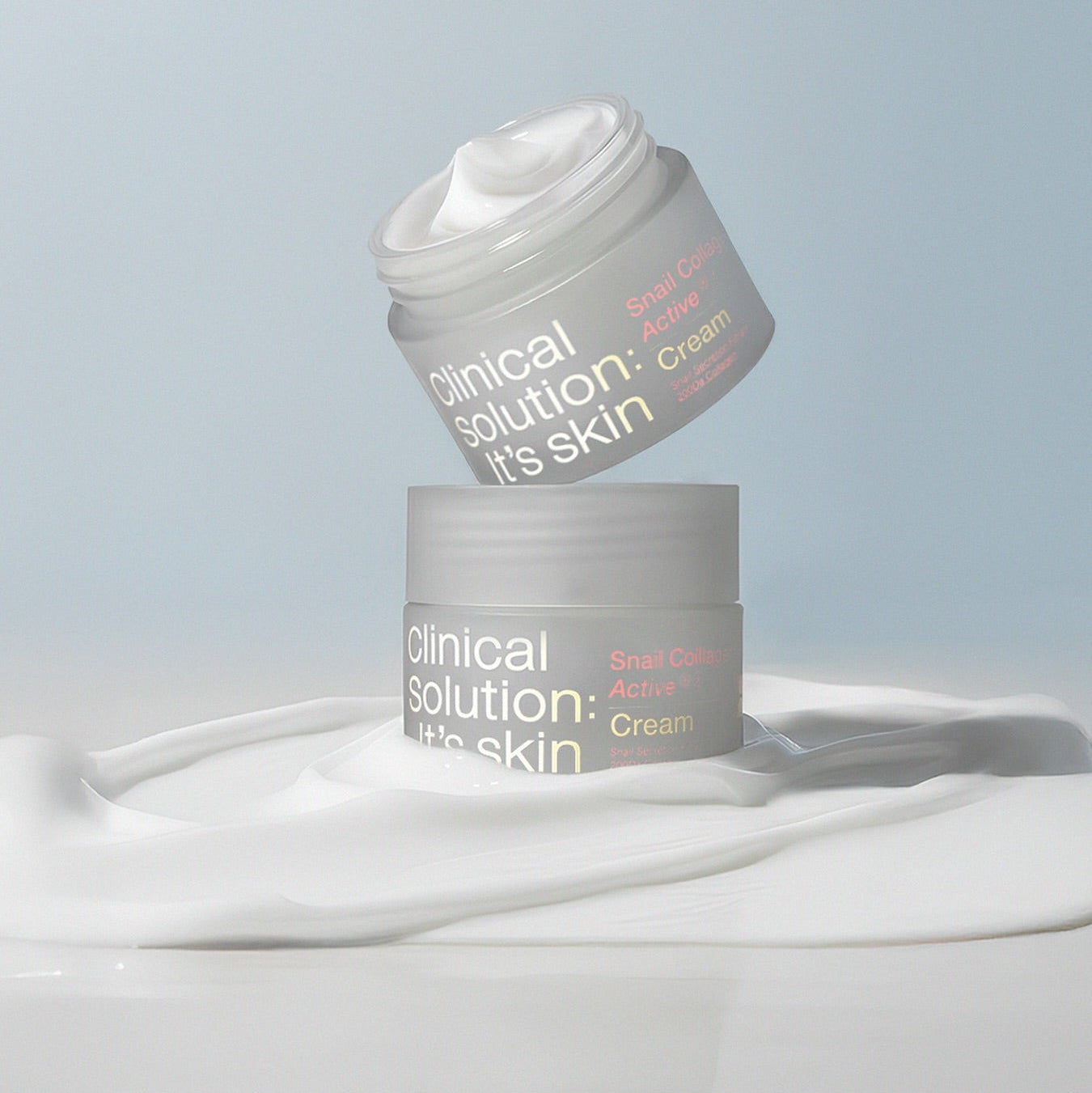 IT'S SKIN Snail Collagen Active Cream 50ml jars on a swirling cream background