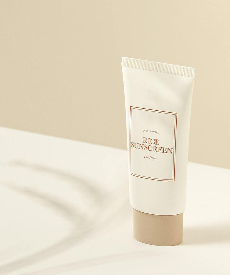 I'M FROM Rice Sunscreen 50ml tube on a beige background with shadow.