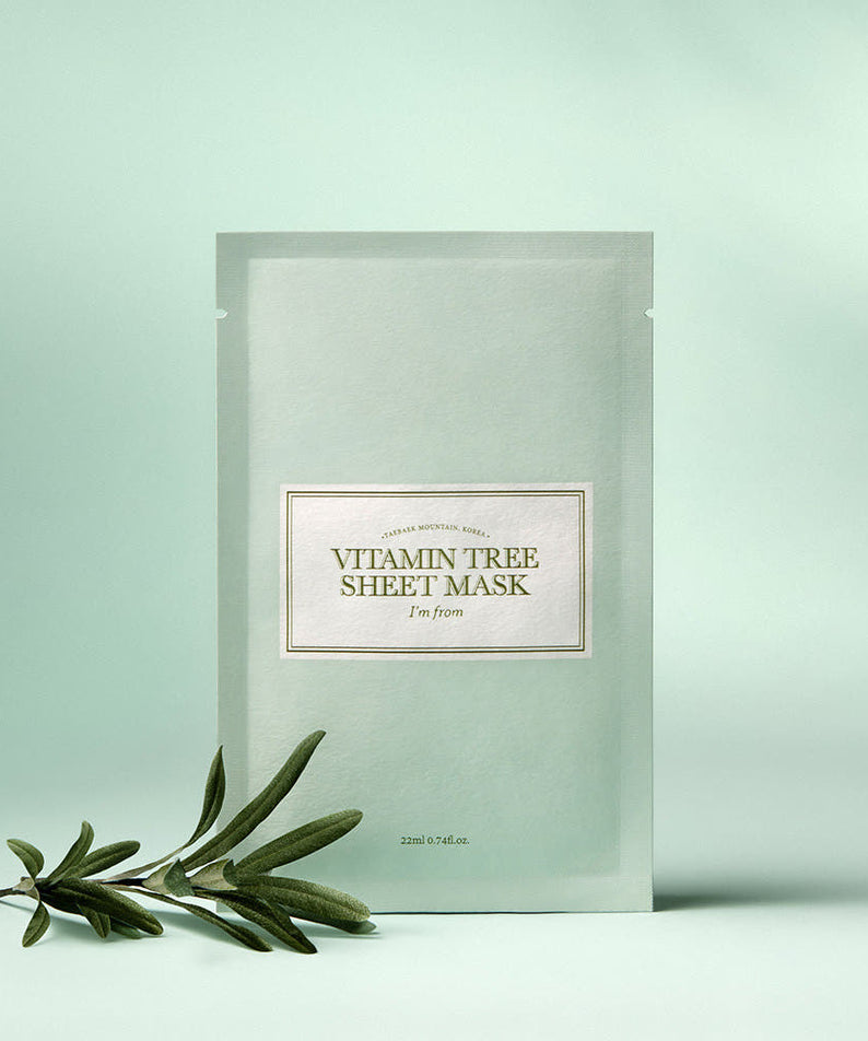 I'M FROM Vitamin Tree Sheet Mask displayed with greenery on a light green background.