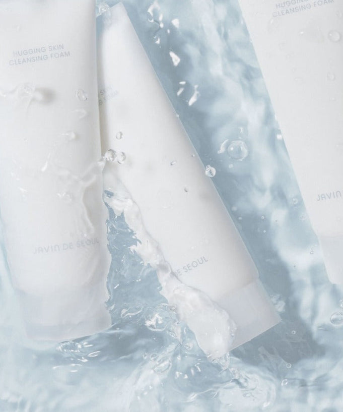 JAVIN DE SEOUL Hugging Skin Cleansing Foam 150ml tubes in water, showcasing product packaging and design.