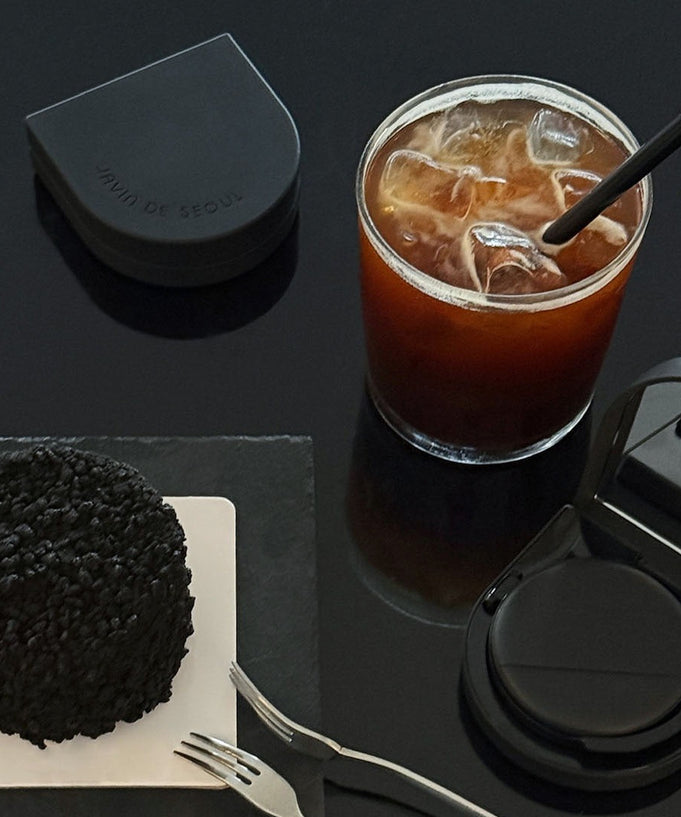 JAVIN DE SEOUL Wink Cushion Glow 16g with iced coffee and snack on a table