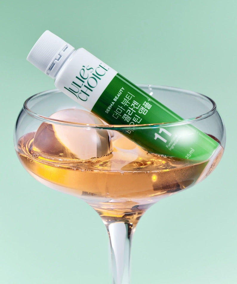 JULIE'S CHOICE Derma Beauty Collagen Biotin Ampoule 25ml in a glass with ice, showcasing the beauty product in a stylish setting.