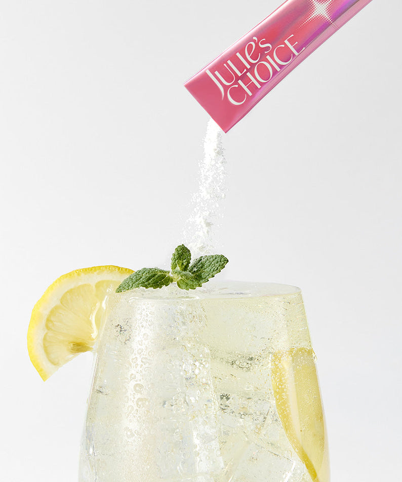 JULIE'S CHOICE Vita Glow High Glutathione C powder being poured into refreshing lemon mint drink