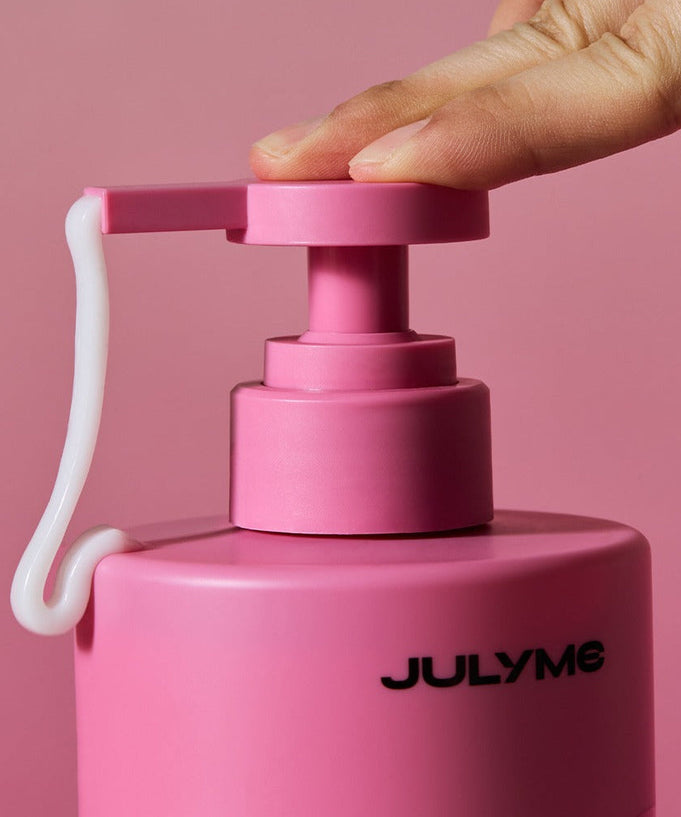 Close-up of JULYME Damage Care Perfume Hair Treatment 500ml pump dispenser being pressed, showcasing the product's design and texture.