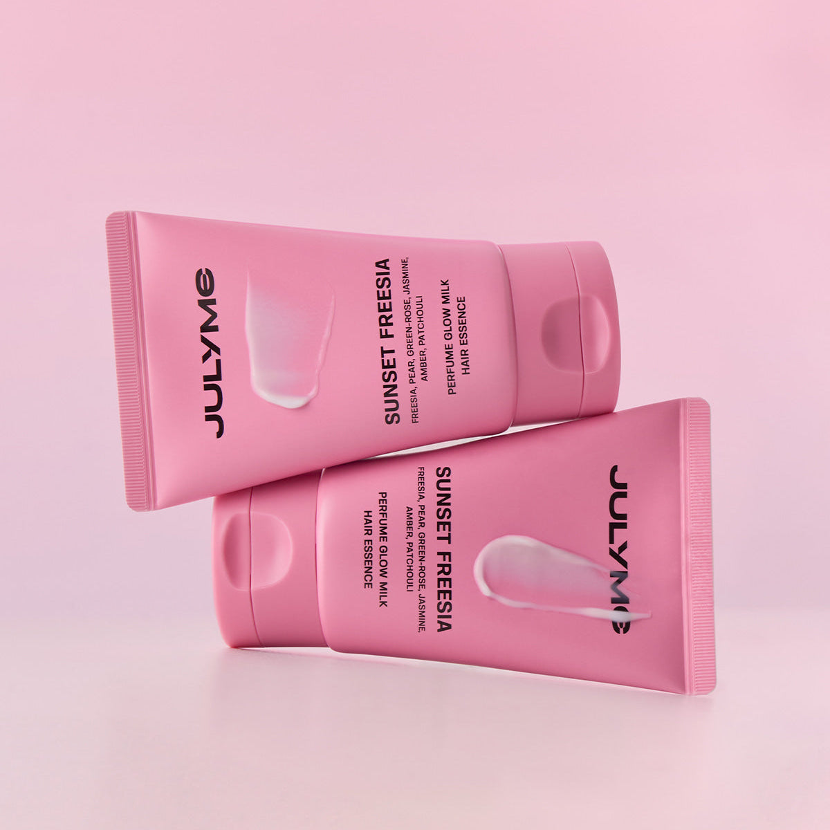 JULYME Perfume Glow Milk Hair Essence 80ml (Sunset Freesia) in pink bottles with minimalistic design
