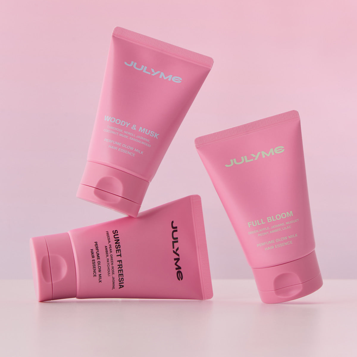 JULYME Perfume Glow Milk Hair Essence 80ml (Woody& Musk) in pink packaging, showcasing luxurious hair care with woody and musk scent.