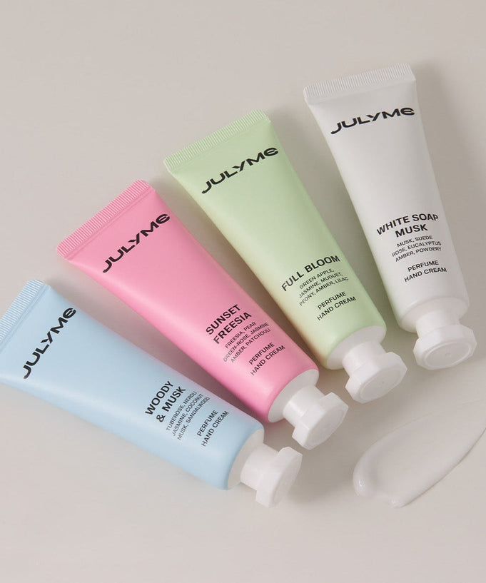 JULYME Perfume Shea Butter Hand Cream 30ml and other fragrance hand creams in colorful tubes displayed on a surface.