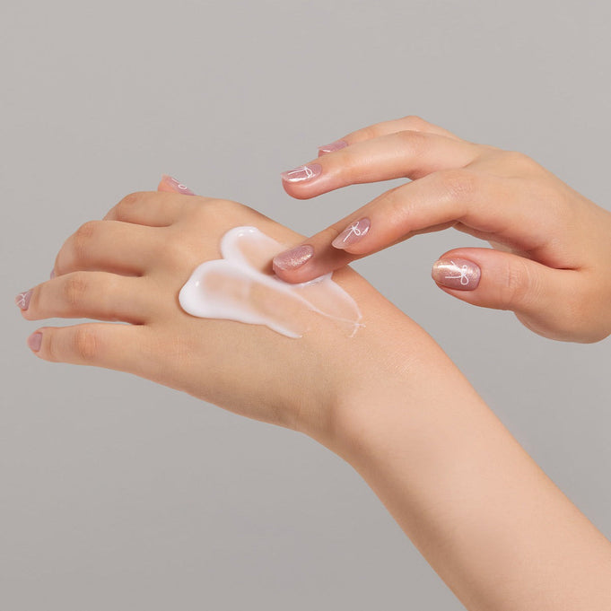 Applying JULYME Perfume Shea Butter Hand Cream 30ml on hands for smooth and moisturized skin.