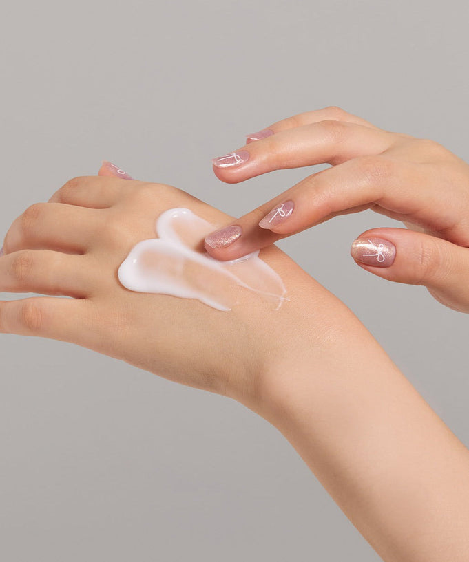 Applying JULYME Perfume Shea Butter Hand Cream 30ml on hands for smooth and moisturized skin.