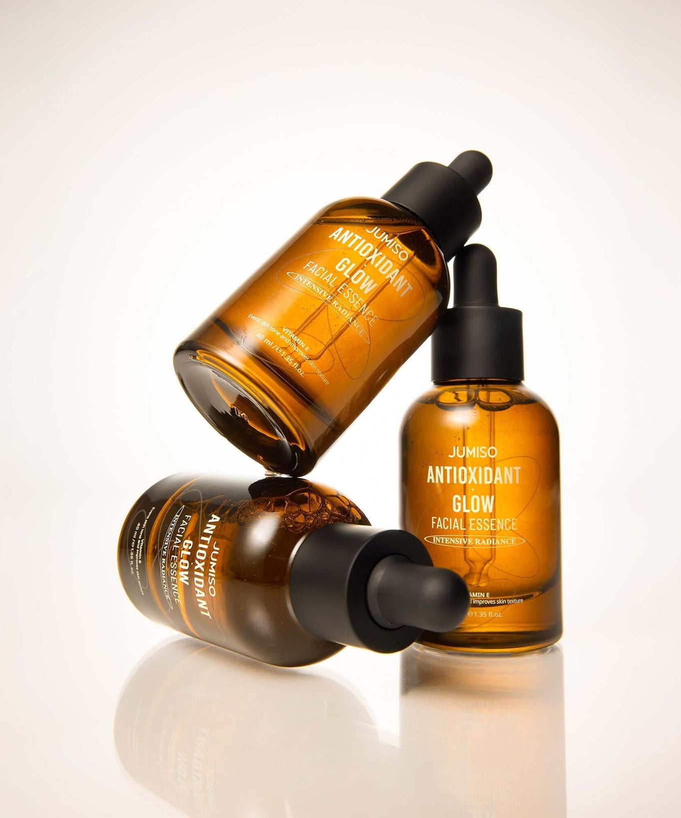 JUMISO Antioxidant Glow Facial Essence bottles showcasing radiant skincare essence in amber glass packaging.