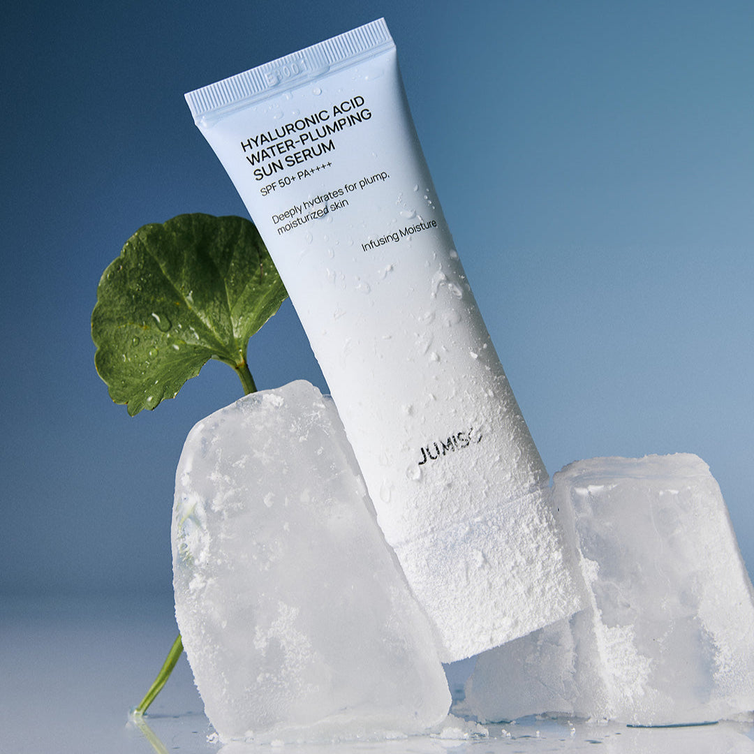 JUMISO Hyaluronic Acid Water Plumping Moisture Sun Serum 40ml with ice cubes and leaf background for hydration.