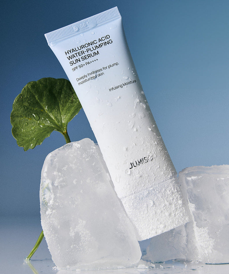 JUMISO Hyaluronic Acid Water Plumping Moisture Sun Serum 40ml with ice cubes and leaf background for hydration.