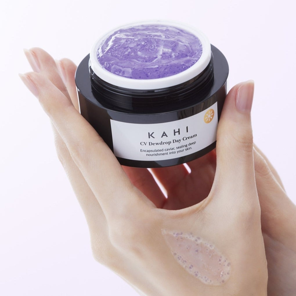 KAHI CV Dewdrop Day Cream 50ml jar held in hand, showing product texture