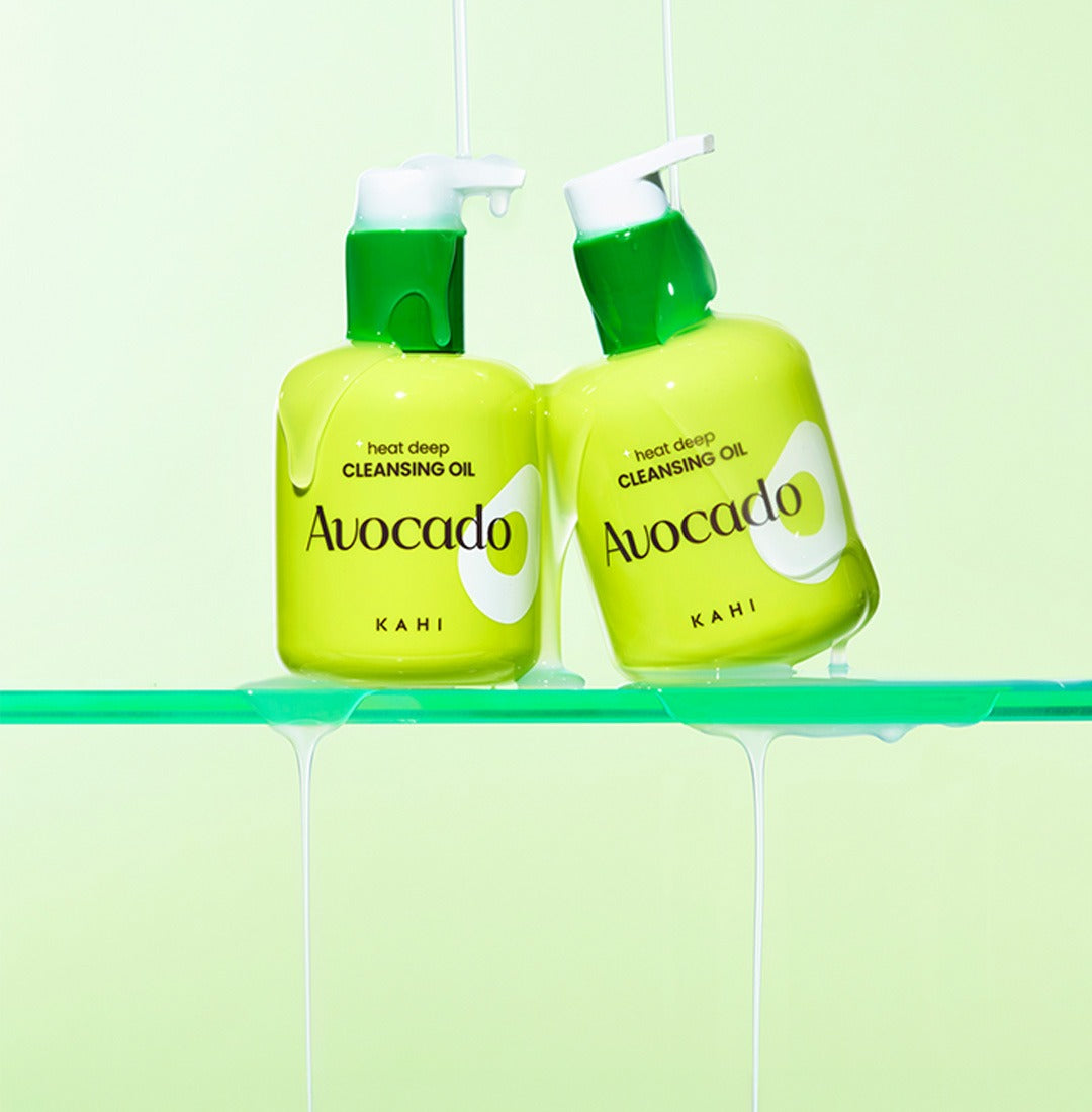 KAHI Heat Deep Cleansing Oil 200ml in green avocado packaging with pumps, displayed against a light green backdrop.