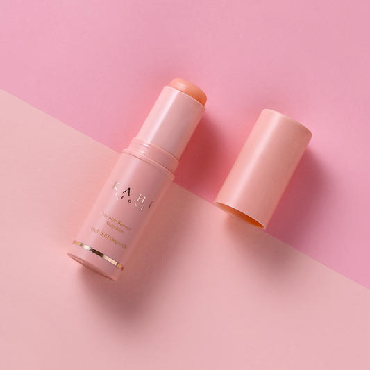 KAHI Wrinkle Bounce Multi Balm 9g displayed on a pink background, highlighting its skincare benefits for reducing wrinkles and hydrating skin.
