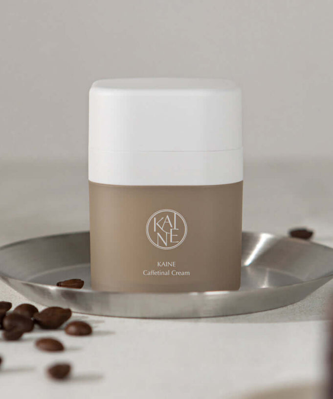 KAINE Caffetinal Cream 50ml on a tray with coffee beans